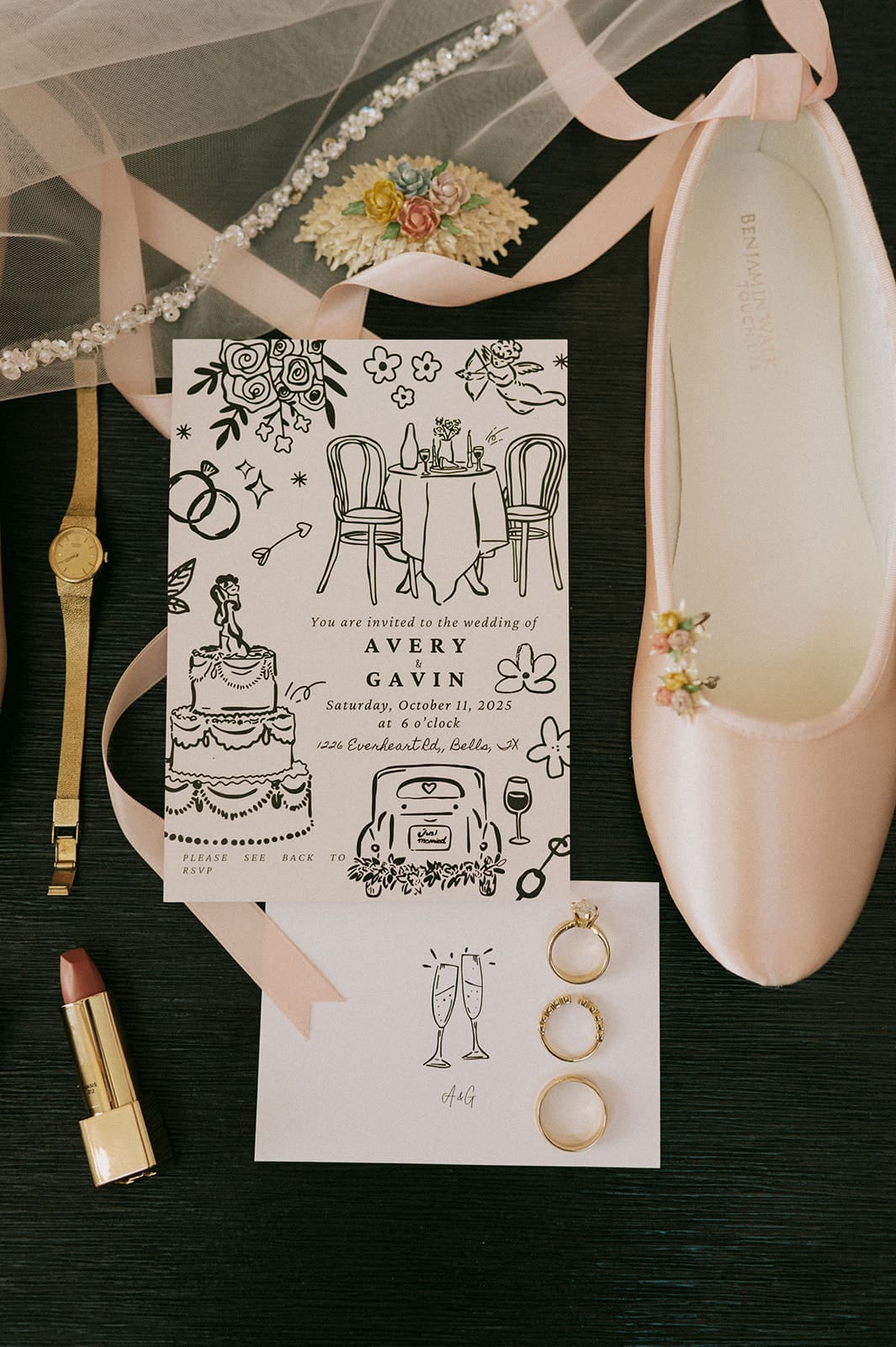 Flat lay of wedding items including a wedding invitation, a pink shoe, three rings, a gold watch, lipstick, veil, and a decorated envelope.