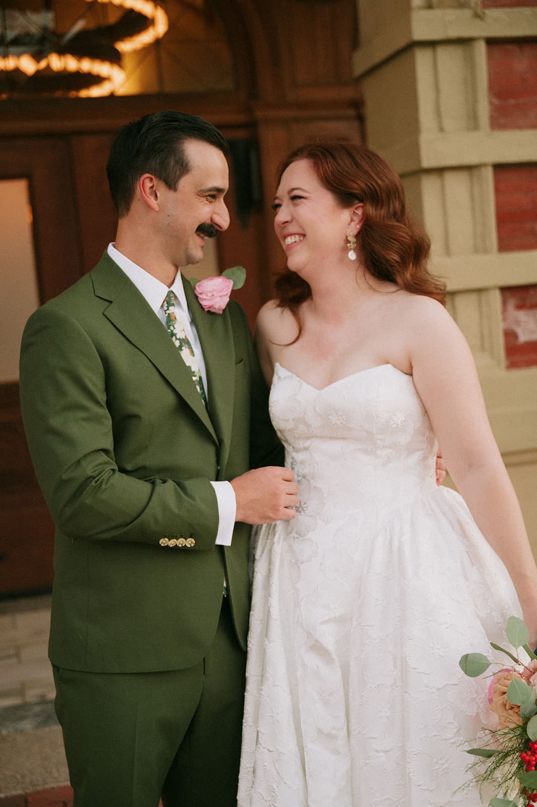 bride and groom take wedding portaits outside of The Ashton Depot in Fort Worth