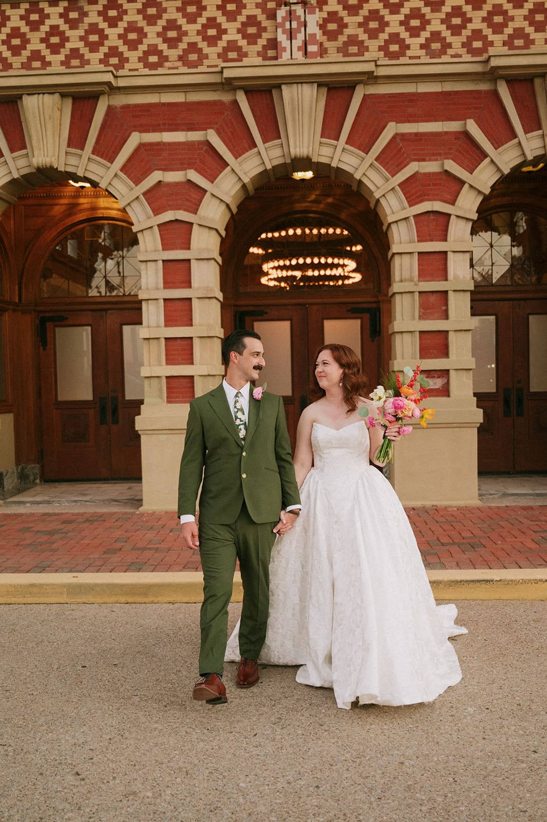 bride and groom take wedding portaits outside of The Ashton Depot in Fort Worth