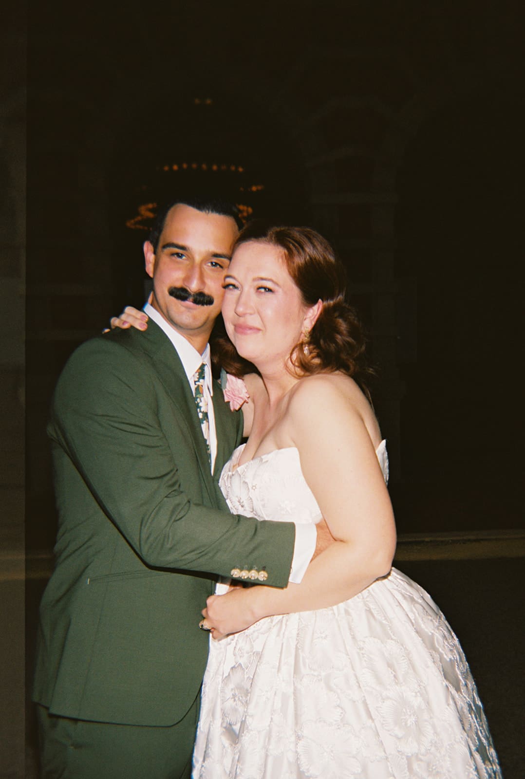 bride and groom take wedding portaits outside of The Ashton Depot in Fort Worth