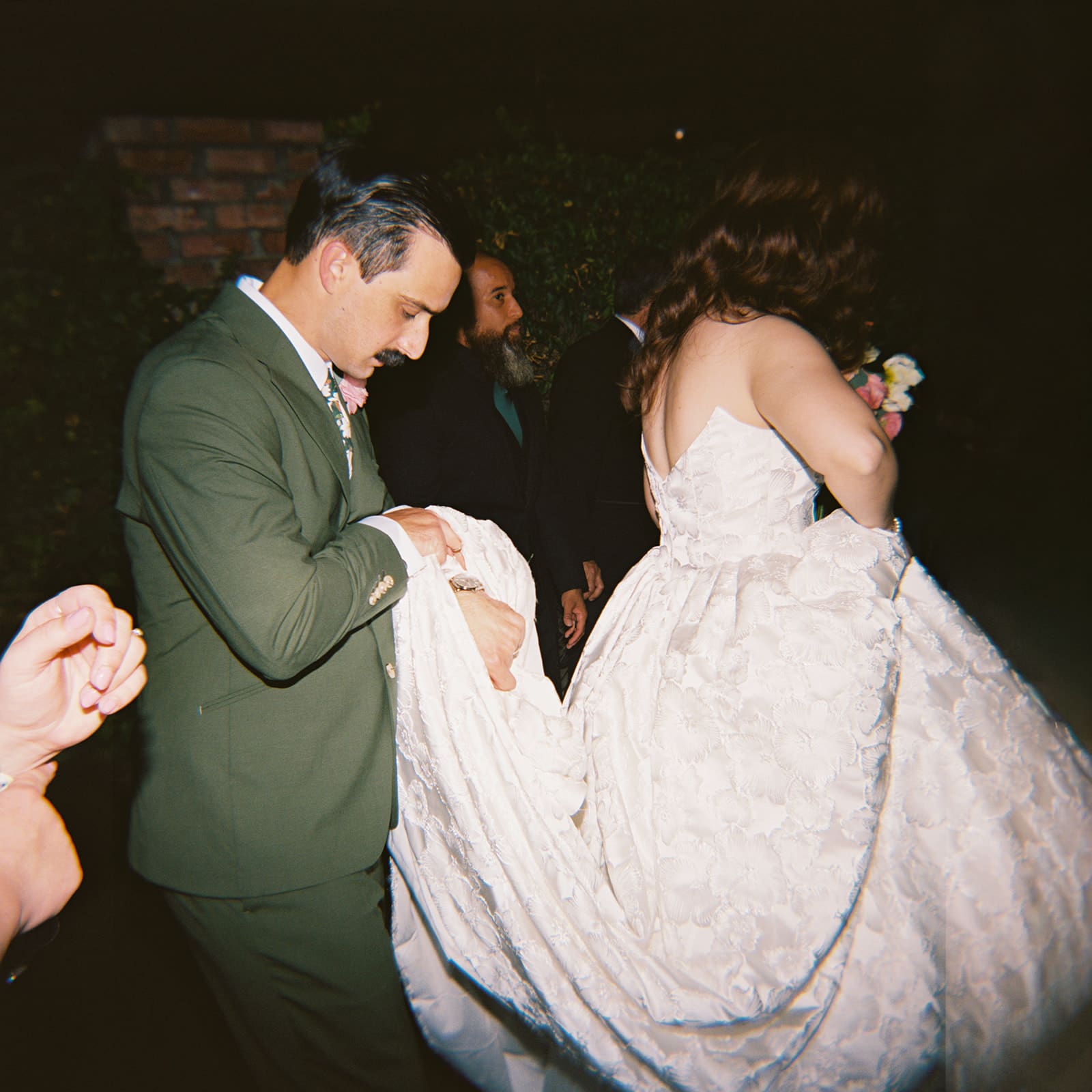 bride and groom take wedding portaits outside of The Ashton Depot in Fort Worth