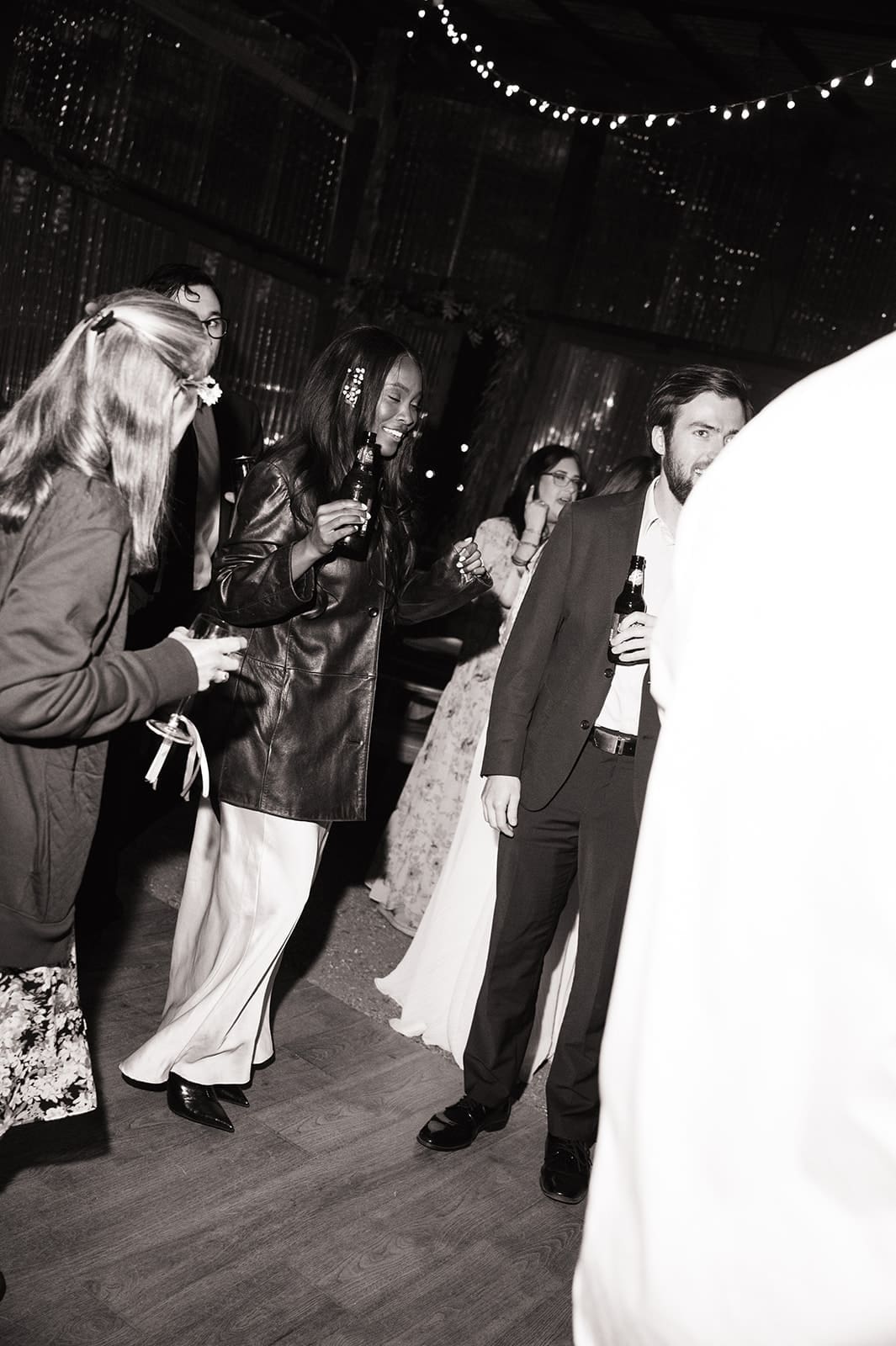 a group of people dancing on the dance floor at a wedding