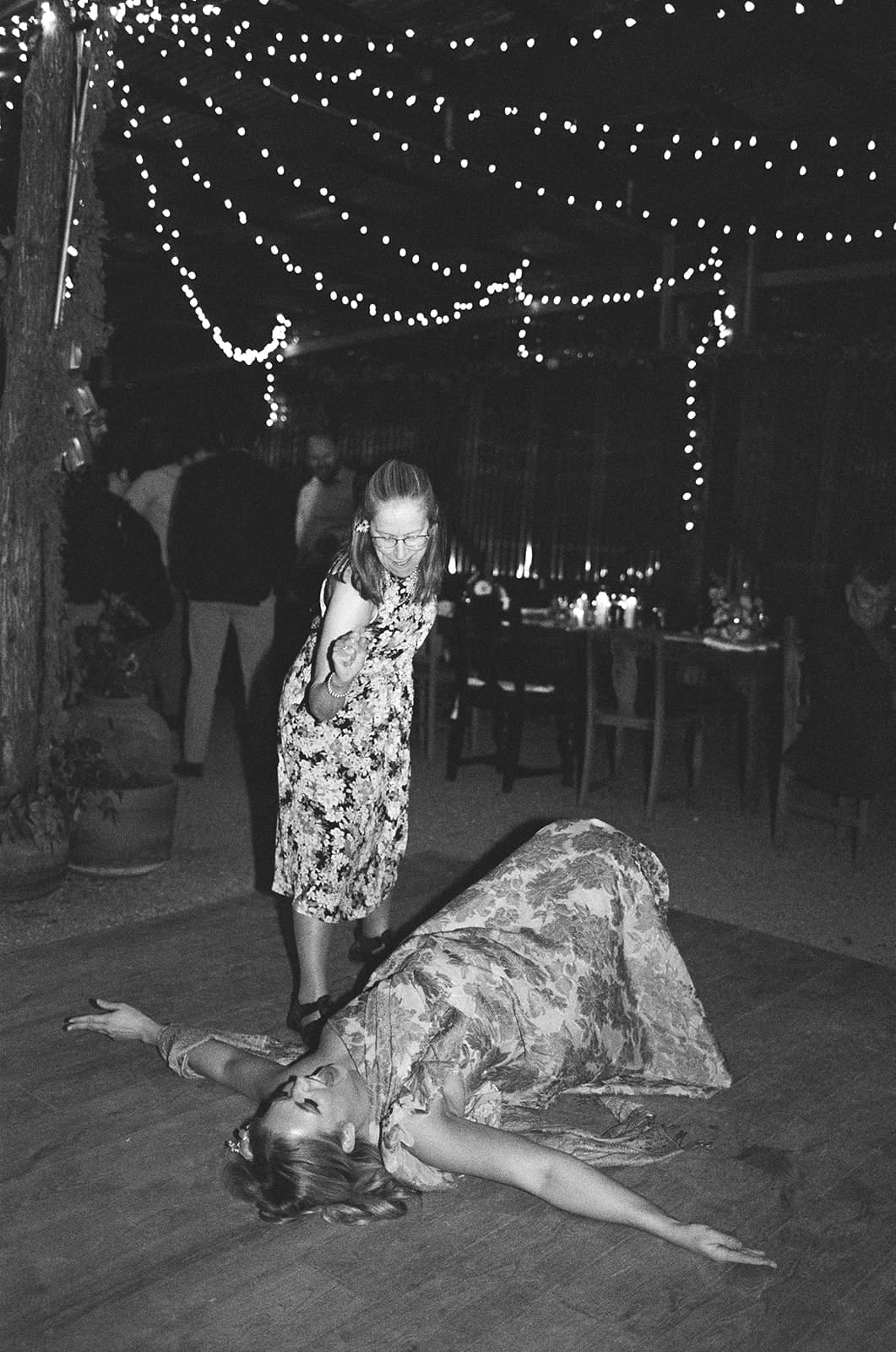 a group of people dancing on the dance floor at a wedding
