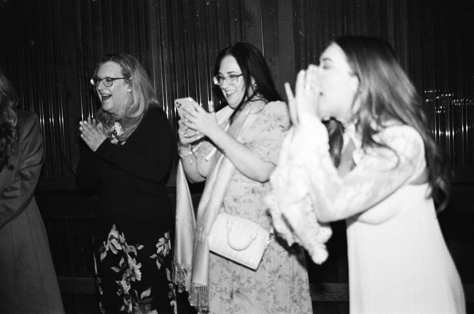 a group of people dancing on the dance floor at a wedding