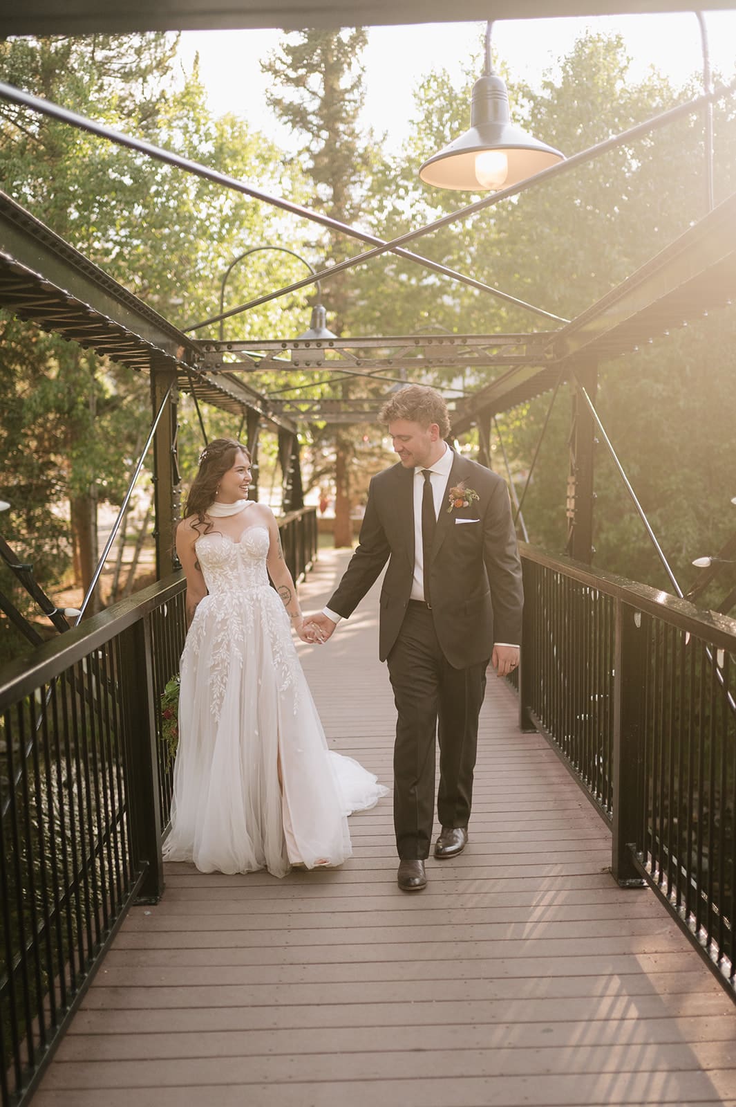 Newlyweds walking together at Silverthorne Pavilion after their Colorado wedding ceremony