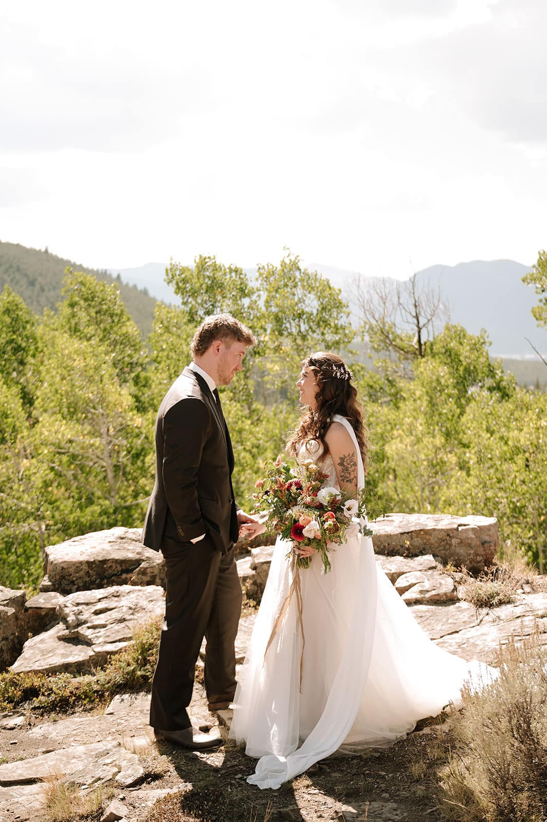 Bride and groom together during outdoor wedding portraits surrounded by Colorado mountain scenery