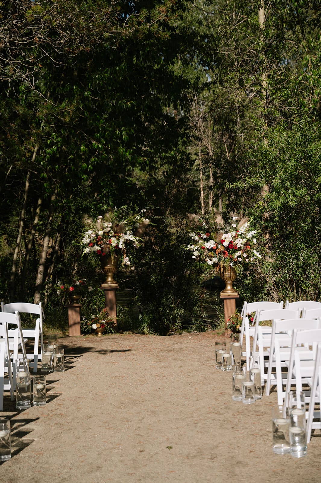 Outdoor ceremony setup surrounded by trees at a small wedding venue in Colorado