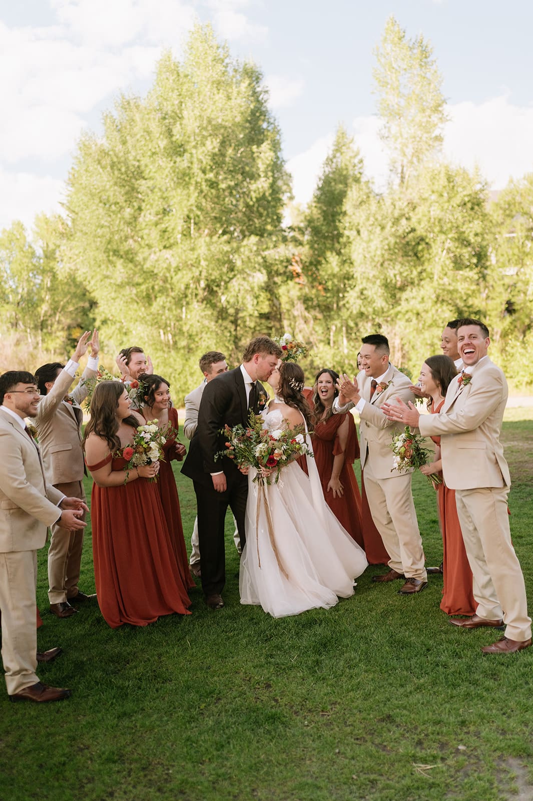 ride and groom celebrating with their wedding party at an intimate Colorado wedding